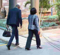 Kenyans Online React to Photo of Gender CS Sicily Kariuki's Bodyguard Carrying Her Handbag