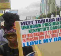 Photo of a Placard Carrying Woman Claiming to be President Uhuru's 'Uknown' Daughter Goes Viral Online