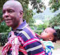 Photo of Makueni Governor Prof Kivutha Kibwana Carrying Child on His Back Goes Viral Online 
