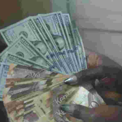 An Employee at a Forex Bureau Holding a Thousand Kenyan Notes and a Hundred Dollar Bills Nairobi Residents Divided Over Food Vendor's Dollar-Only Policy