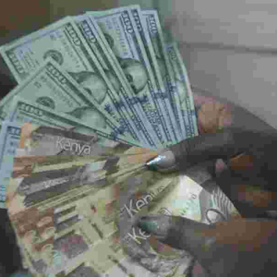 A Cashier at a Nairobi Forex Bureau Counts Dollars and Shilling Notes The Kenyan Shilling Gains Strength Against the US Dollar