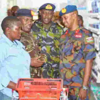 KDF Officers Interact With a Shopper at one of DEFCO's Retail Chains The Rise of KDF's Supermarket Chain Generating Sh1 Billion in Turnover