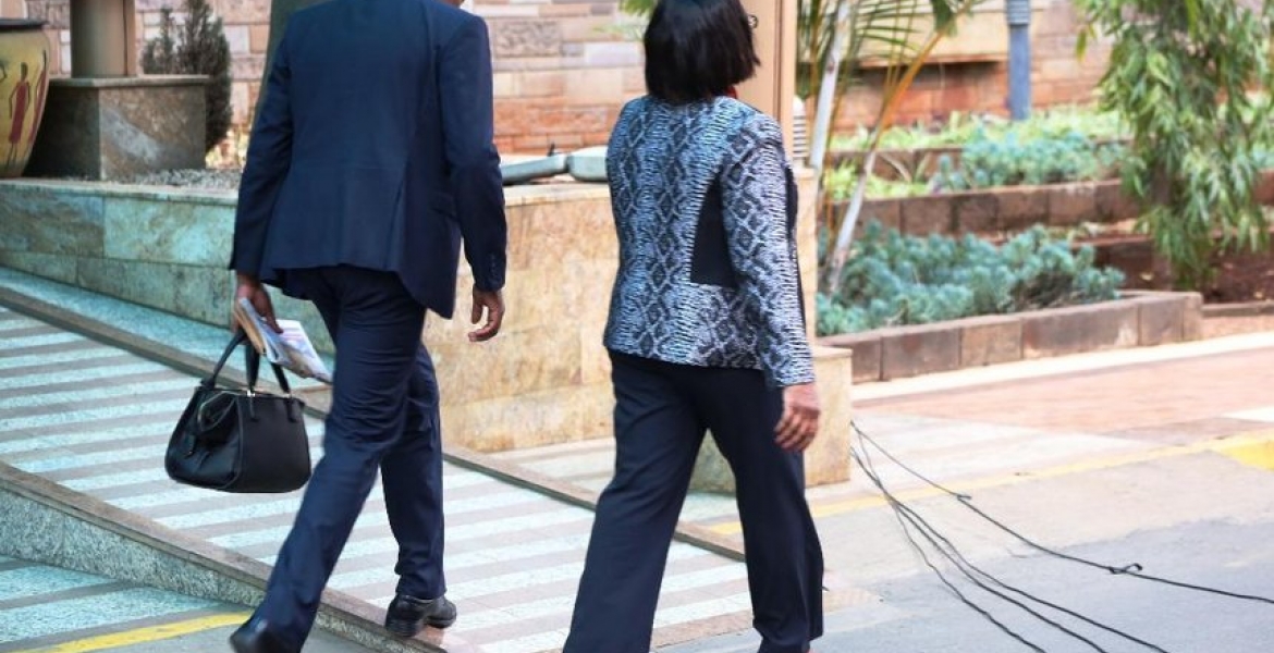 Kenyans Online React to Photo of Gender CS Sicily Kariuki's Bodyguard Carrying Her Handbag