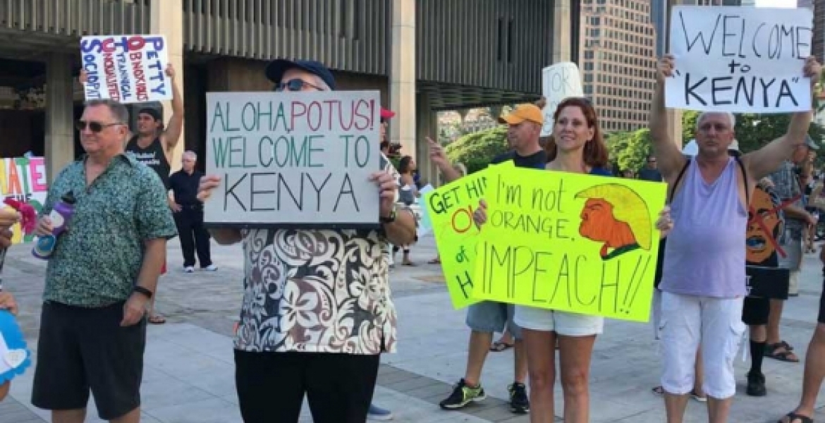 Protesters Carrying &quot;Welcome to Kenya&quot; Placards Welcome President Donald Trump in Hawaii