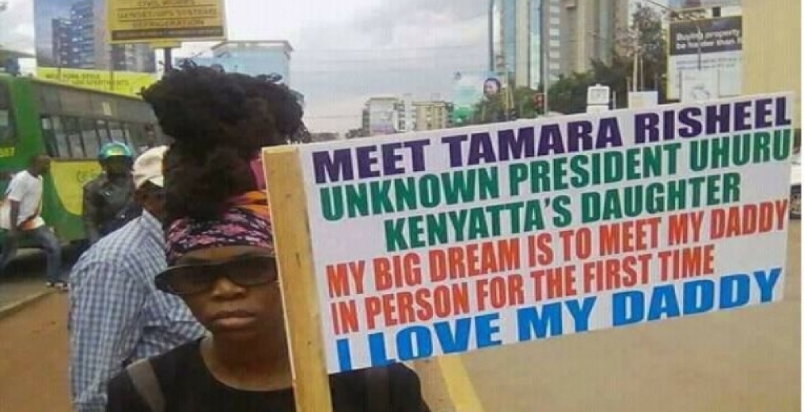 Photo of a Placard Carrying Woman Claiming to be President Uhuru's 'Uknown' Daughter Goes Viral Online