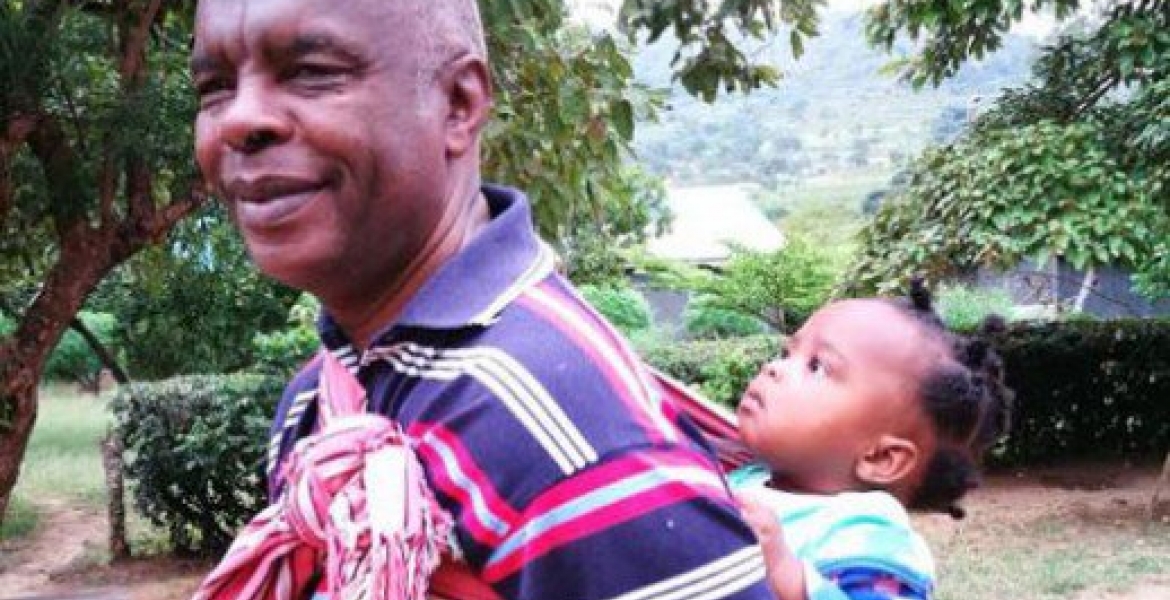 Photo of Makueni Governor Prof Kivutha Kibwana Carrying Child on His Back Goes Viral Online