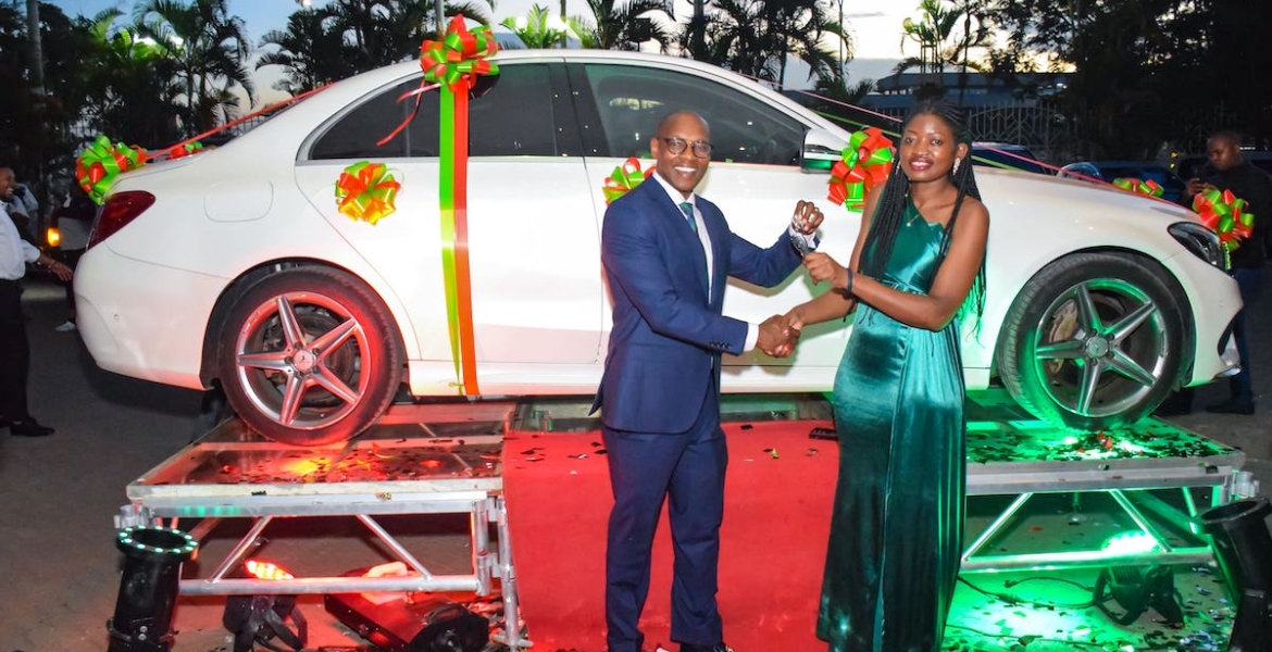 Reuben Kimani, CEO, Username Investments (left) handing over car keys to Esther Naima, Assistant Sales Manager after she won Employee of the Year Award Username Investments Rewards Top Performer with a Dream Car during the 5th Annual Thimini Awards