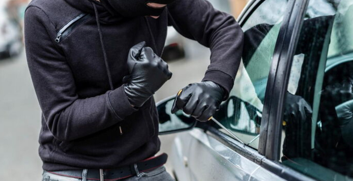 Someone Trying to Break into a Parked car How Criminals in Kenya Use Signal Jammers to Steal Vehicles Without a Trace